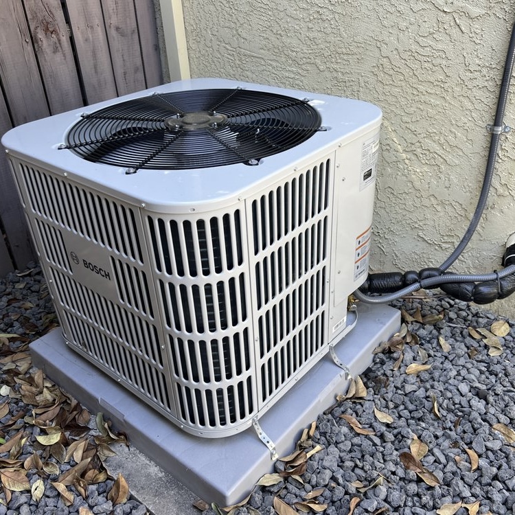 Bosch AC condenser newly installed on gravel pad in Rancho Cordova
