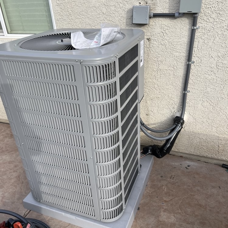 New AC condenser installed on pad outside Sacramento area home