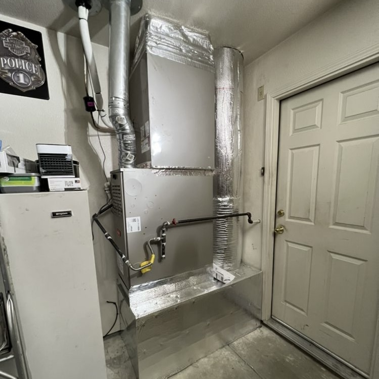 New furnace and air handler installed in garage with ductwork in Sacramento