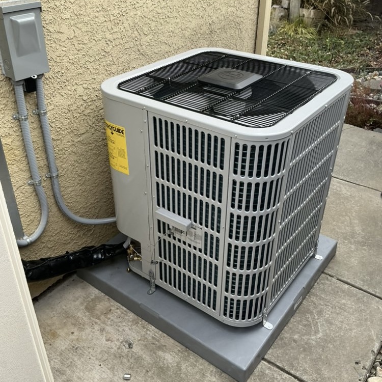 New Carrier AC condenser installed on concrete pad in Sacramento