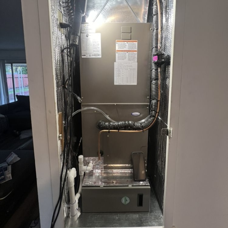 Air handler and furnace installed in interior closet with refrigerant lines and condensate drain