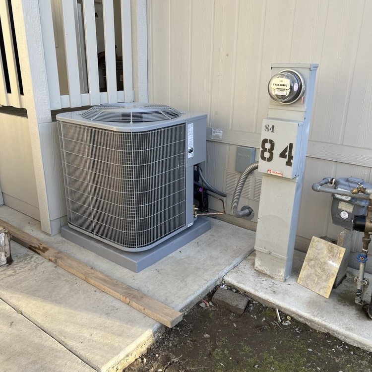Residential AC condenser installation at apartment complex in Sacramento