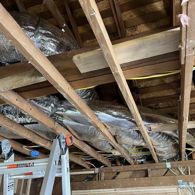 New flex ductwork installed in open ceiling during residential construction