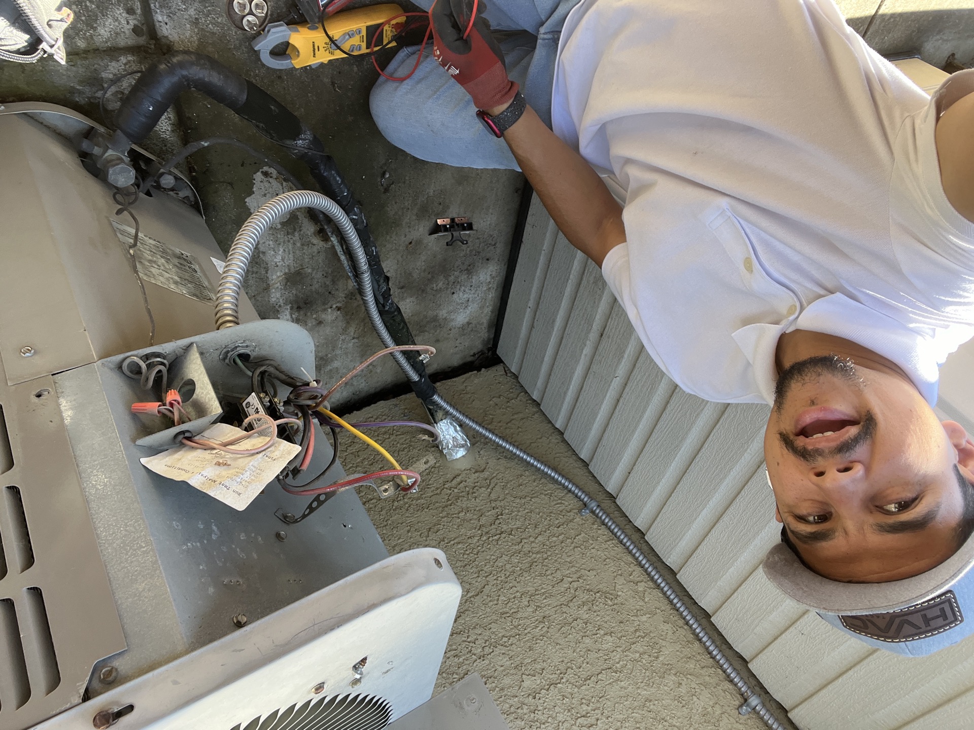 HVAC repair technician inspecting heating and air conditioning system
