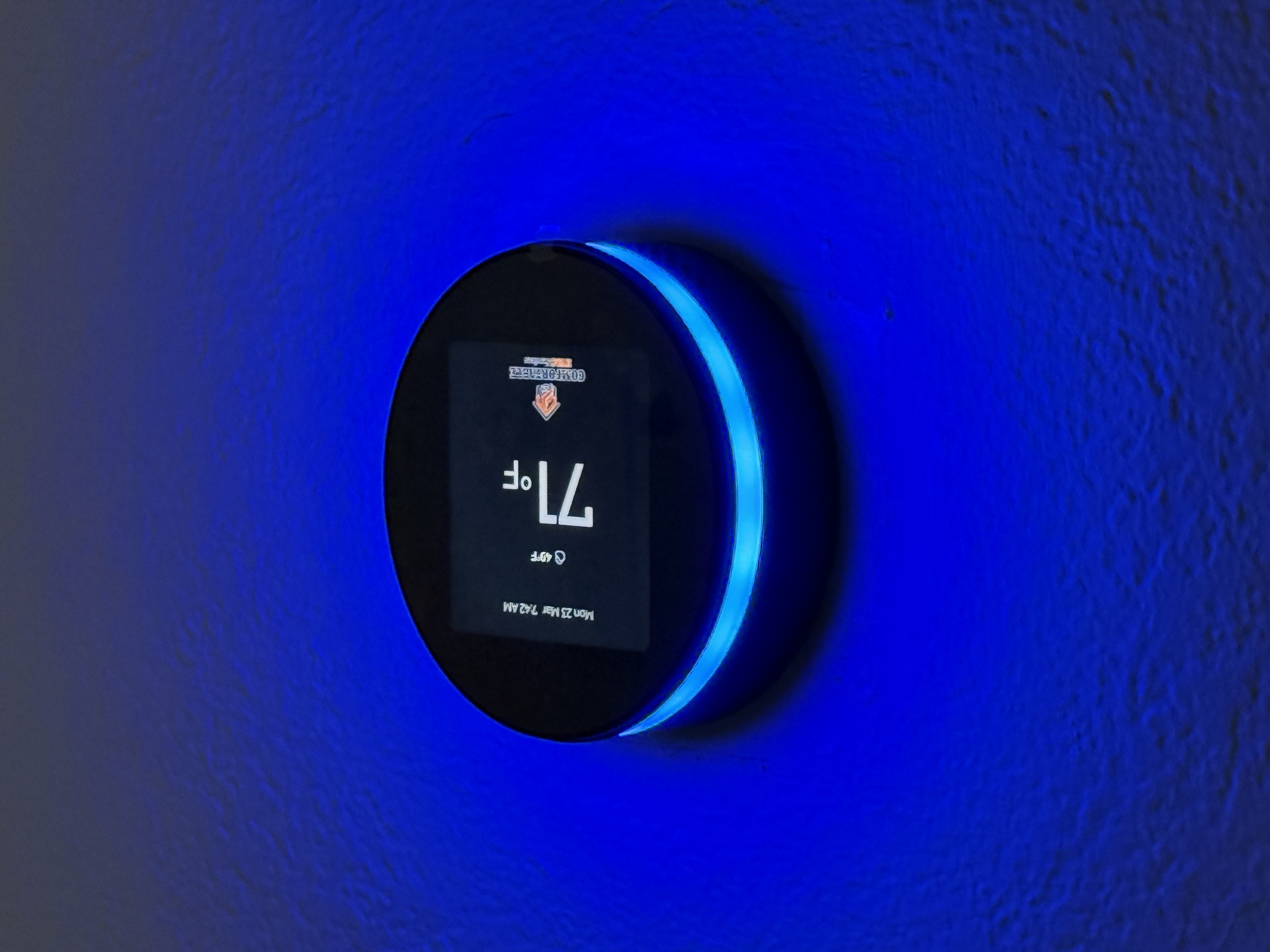Smart thermostat with blue glow installed by Comfortable HVAC Services in Sacramento